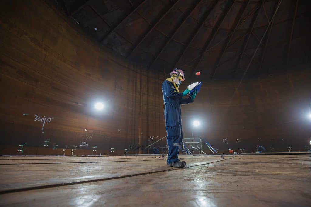 Male worker inspection visual record draft tank oil bottom steel weld